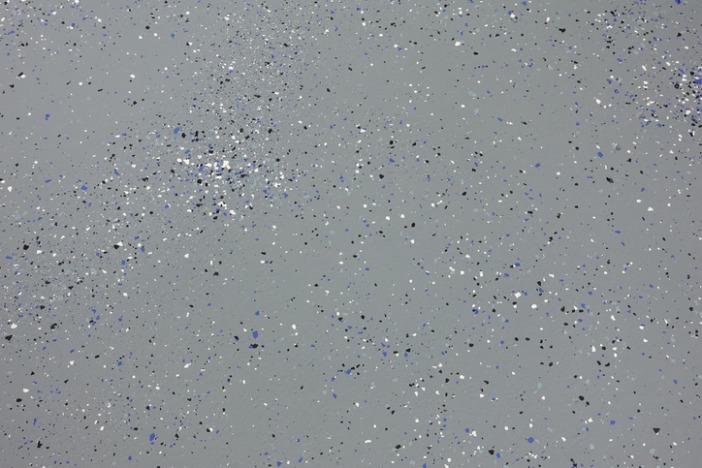 Gray epoxy floor with scattered black, white, and blue flakes in St. Augustine