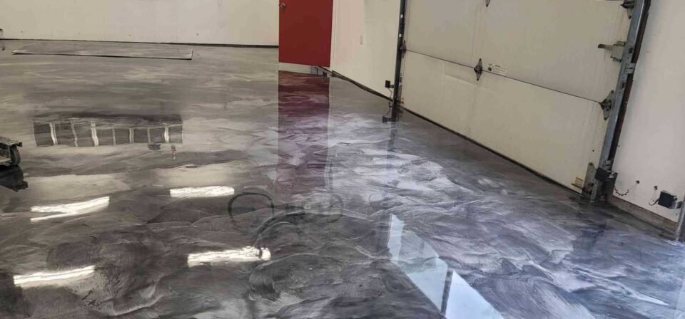 Glossy marbled epoxy floor in garage space by Custom Floor Coating