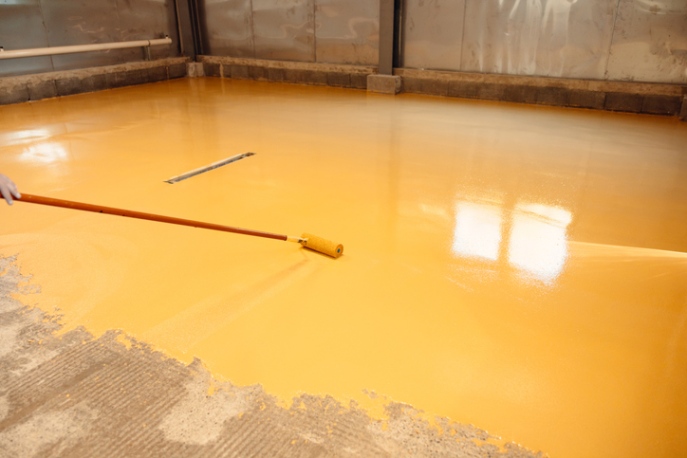 Yellow epoxy coating applied to concrete floor by Custom Floor Coating