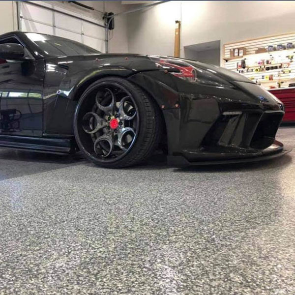 Black car parked on a polished concrete floor in a luxury garage in Jacksonville, FL